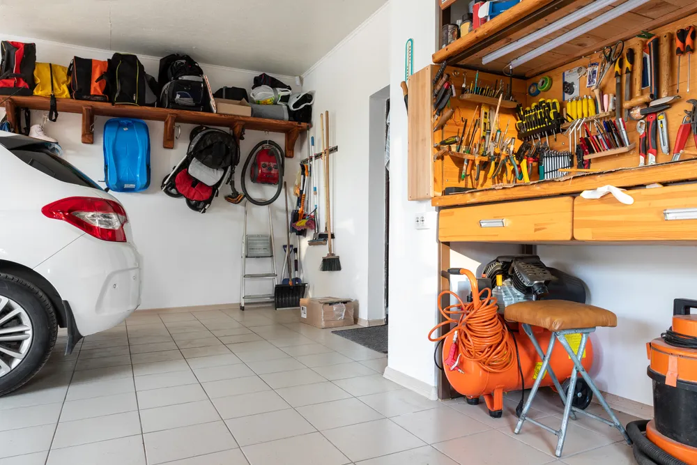 A well-organized garage with labeled shelves, storage bins, and tools neatly arranged.